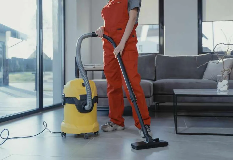 Cleaning professional vacuuming a modern interior